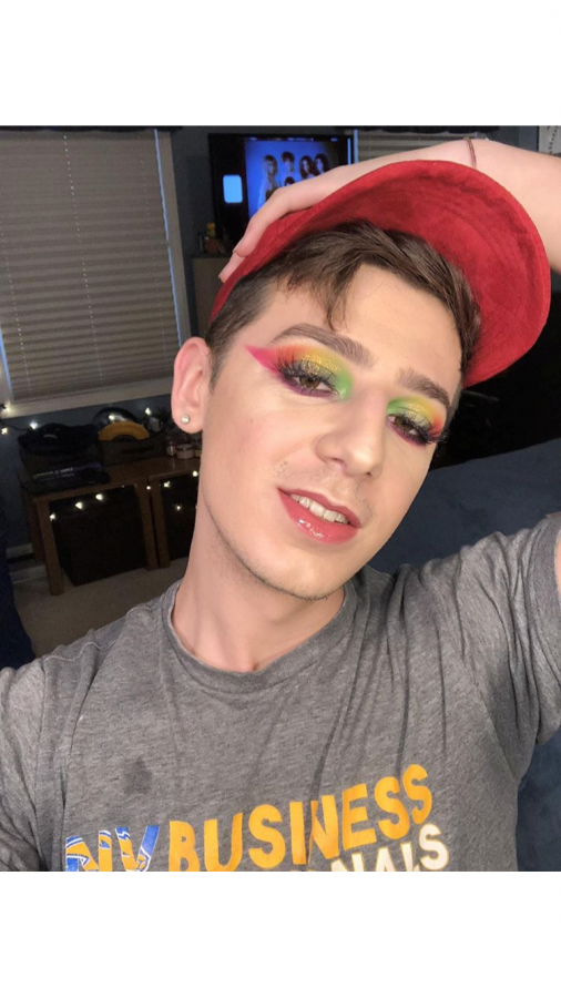 Wearing a re-make of his favorite multicolored makeup look, Meyer smiles confidently.
