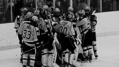 The Neuqua Valley Boy's Varsity Hockey Team huddles during a timeout at a recent hockey game. 
