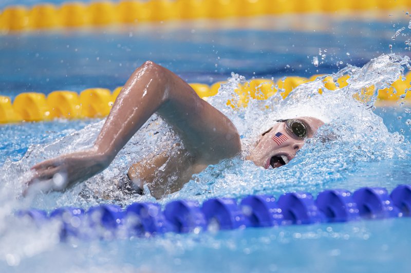 Rachel Stege is swimming freestyle in the 400m race at the World Junior Swimming Championships in Budapest. The American flag is temporarily placed on her cheek as she represents the country on the global stage. Gasping for breath, Stege pulls ahead of her competitors.