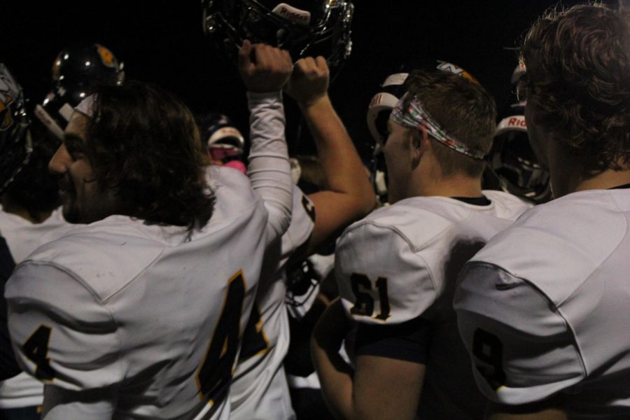 Neuqua Valley advances to the playoffs. This is a photo of the team celebrating with Gold Rush. 