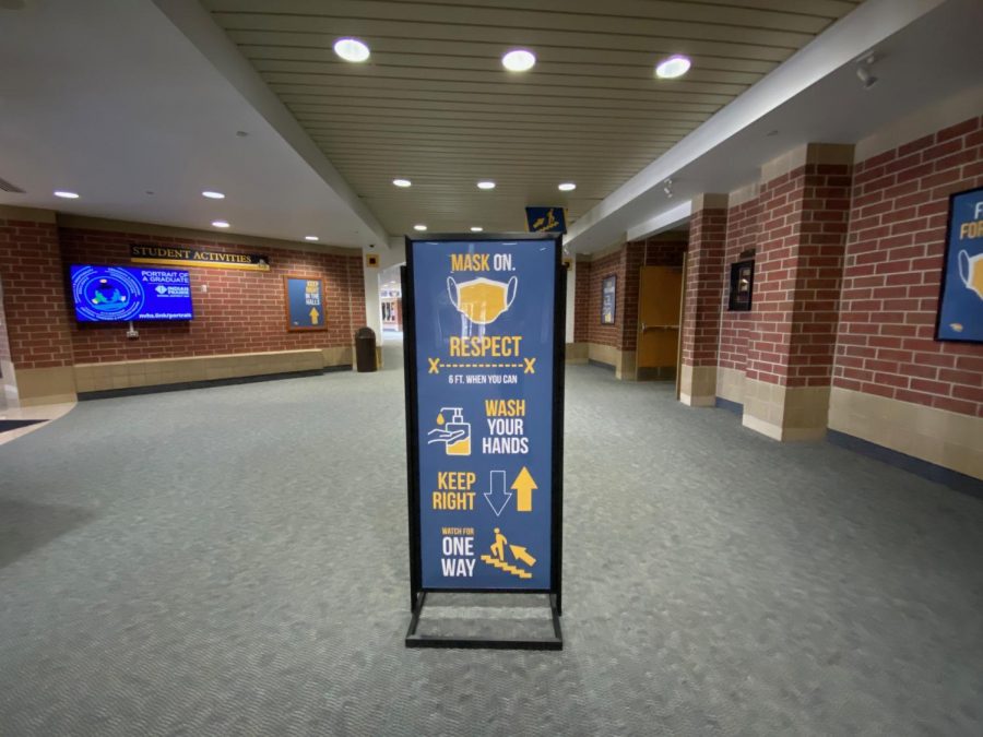 Social distancing and mask wearing signage are on display at all parts of the main hallways.