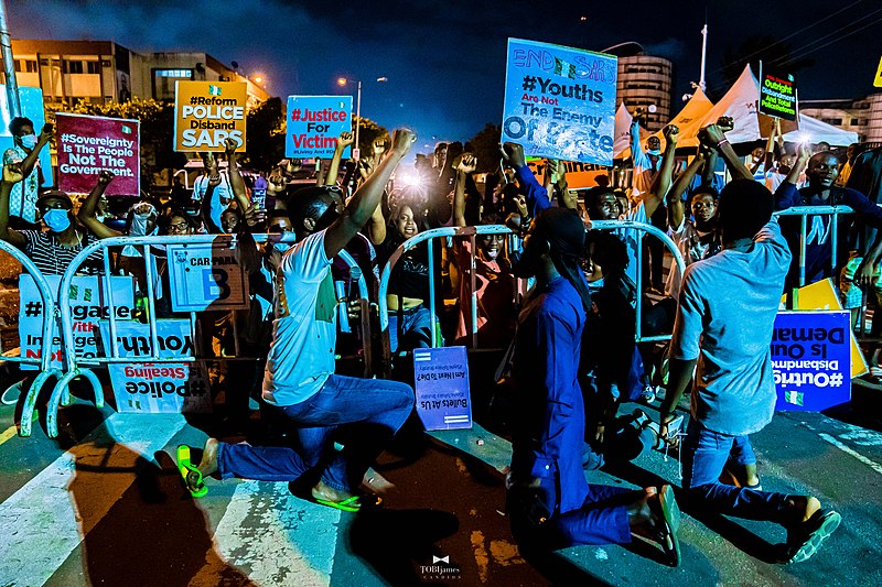 The photo features protesters kneeling when the Nigerian National Anthem played.