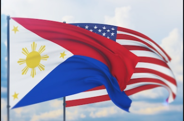 The flag of the Philippines and the US flag flying together in unity.