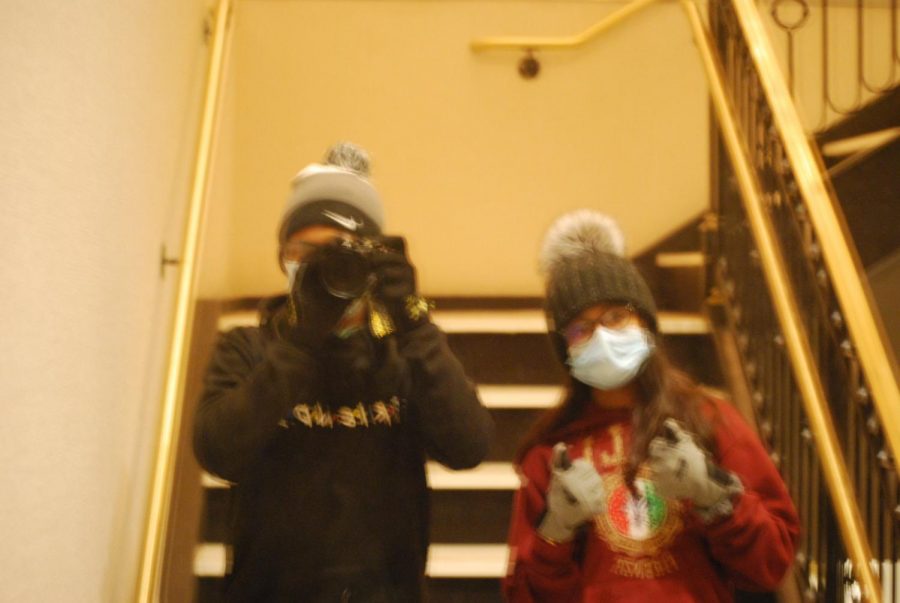 A photograph of Sachin Fong with his sister in front of a mirror.