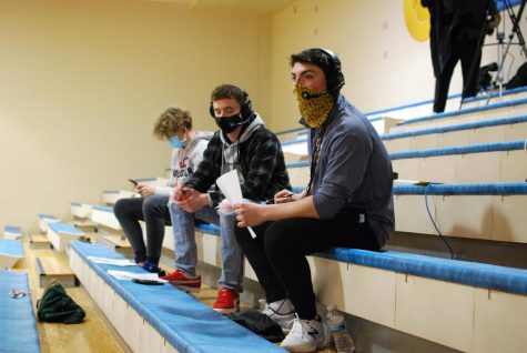 Dominick Liacone commentates on a Neuqua basketball game, accompanied by Jack Ashby and Charlie Rook