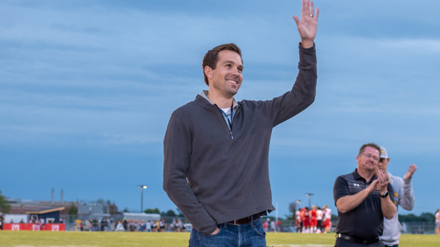 Jake Bender waves at cheering fans in the stands.