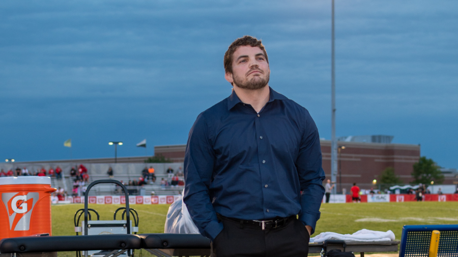 Matt Collum, class of 2004, smiles proudly during his induction. 