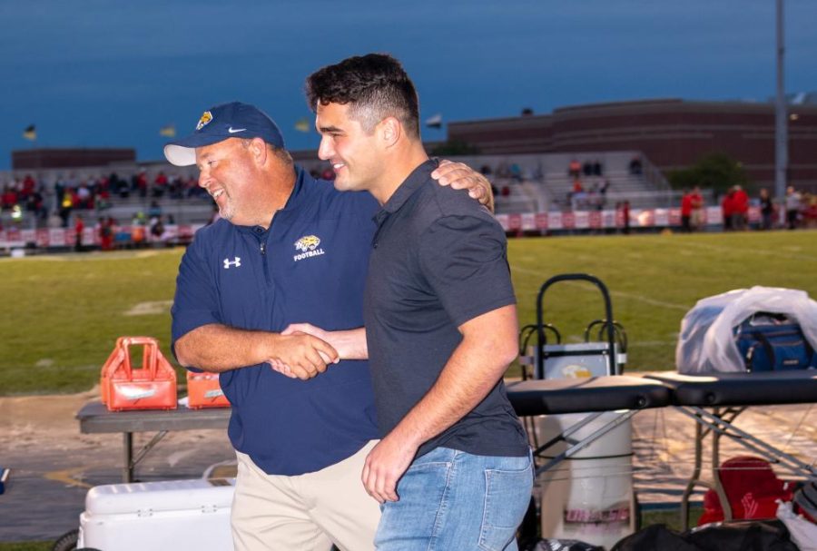 Neuqua Alumni Joey Rhattigan smiles during the Hall of Fame Induction Ceremony at Neuquas homecoming football game.