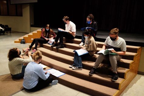 Buddies and volunteers sit and rehearse their lines together.