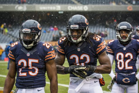 Three non-descript Chicago Bears players standing in all of their mediocrity. 