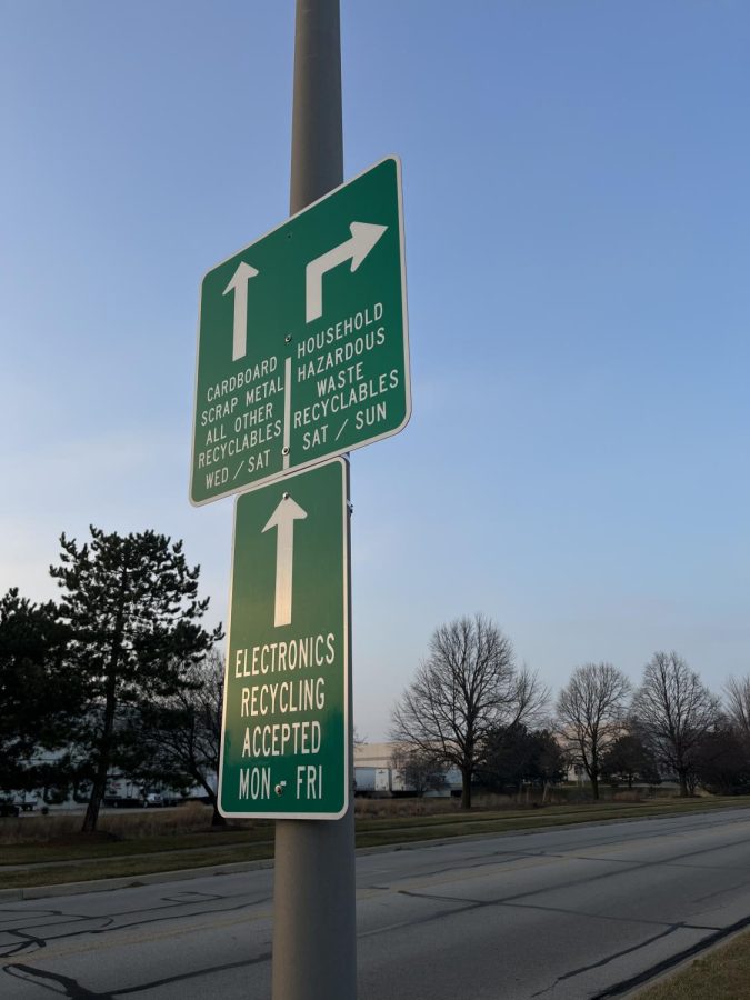 A sign directing people towards different sections of the Naperville Recycling Drop-off.